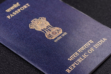 Physical paper international passport of Indian citizen on dark concrete background