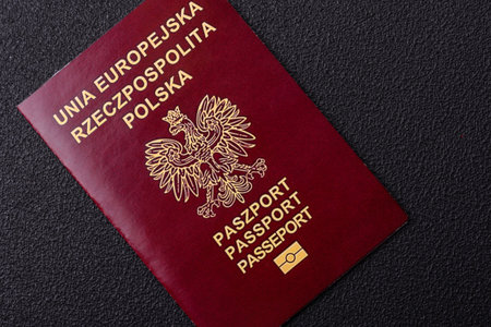 Physical paper international passport of a Polish citizen on a dark concrete backgroundの写真素材