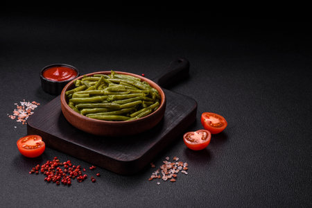 Boiled green bean pods with salt and spices on a dark concrete backgroundの写真素材