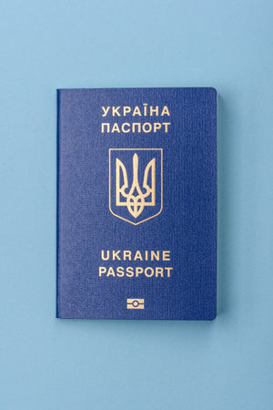 Biometric Ukrainian passport on a blue background. Conceptual background on the theme of tourism and...