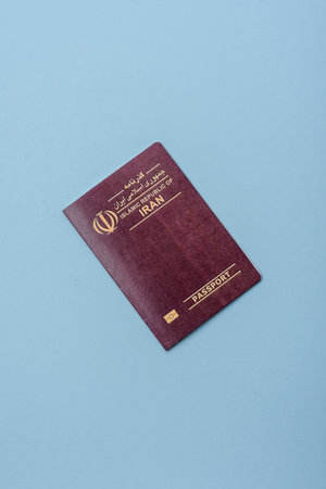 Physical paper international passport of Iranian citizen on a blue backgroundの写真素材