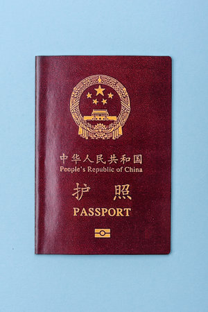 Physical paper international passport of a Chinese citizen on a blue backgroundの写真素材