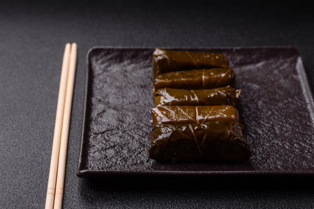 Delicious dolma in the form of rice and meat wrapped in grape leaves or a meat substitute with salt and spicesの写真素材