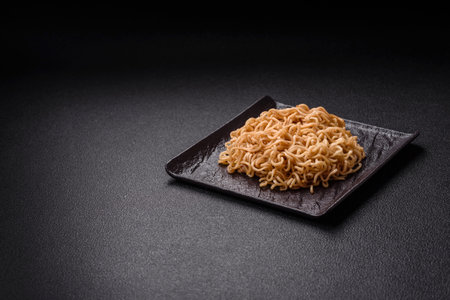 Asian dish rice noodles with salt and spices on dark concrete backgroundの写真素材