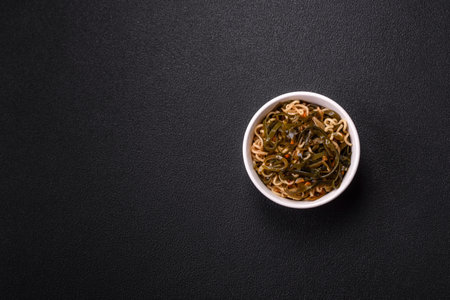 Asian dish rice noodles with salt and spices on dark concrete backgroundの写真素材