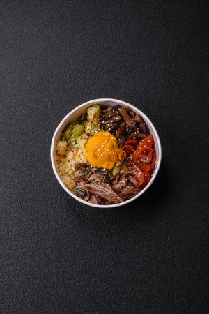 Bowl of food with beef, bulgur, tomatoes, mushrooms, zucchini and sauce. Vegan dishの写真素材