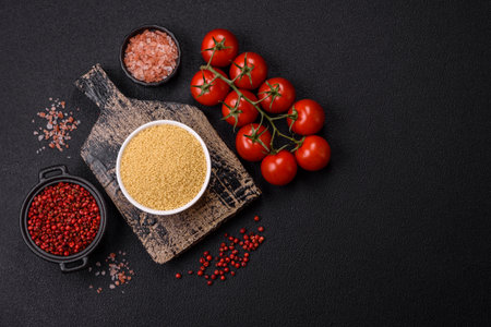 Wheat porridge couscous grains on a dark concrete background. Preparing a delicious, nutritious breakfastの写真素材