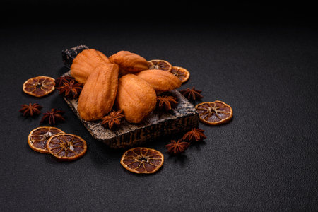 Traditional French biscuits with nutty flavor on a dark concrete background