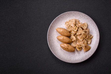 Fish or meat quenelles with delicate mushroom sauce, salt and spices on a dark concrete backgroundの写真素材