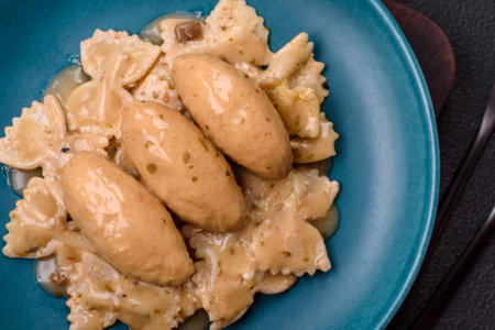 Fish or meat quenelles with delicate mushroom sauce, salt and spices on a dark concrete backgroundの写真素材