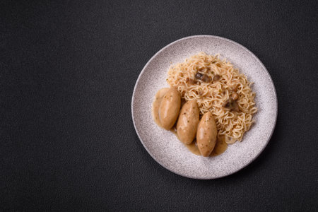 Dumplings with vegetables, salt and spices in mushroom sauce on a dark concrete backgroundの写真素材