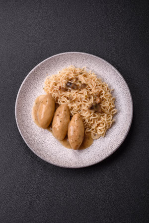 Fish or meat quenelles with vegetables, salt and spices in mushroom sauce on a dark concrete...
