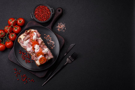 Sandwich with brioche bun, roast beef, tomatoes, stracciatello and vitello tonato sauceの写真素材