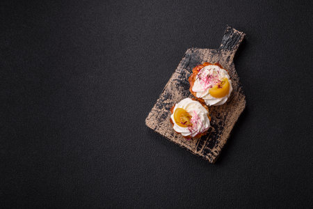 Sweet or sour cupcake with cream cheese and filling on a dark concrete background