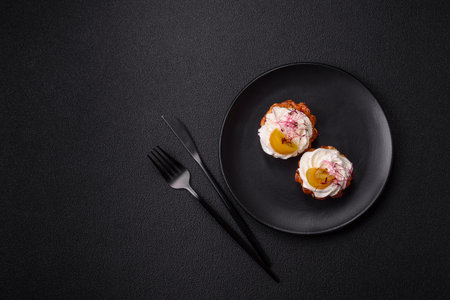 Sweet or sour cupcake with cream cheese, microgreens and filling on a dark concrete backgroundの写真素材