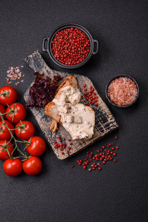 Baked chicken breast with green beans, sesame seeds and sauce on dark concrete backgroundの写真素材