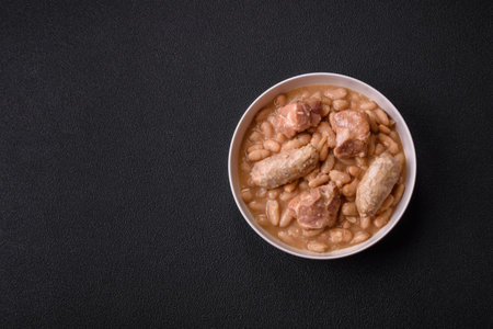 Cassoulet with white beans, meat and sausages, vegetables, salt and spices as a classic French foodの写真素材