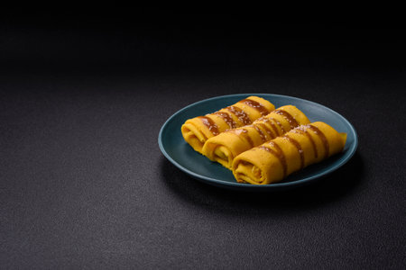 Sweet or savory crepe with different fillings for a hearty breakfast on a dark concrete backgroundの写真素材