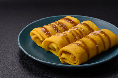 Sweet or savory crepe with different fillings for a hearty breakfast on a dark concrete backgroundの写真素材