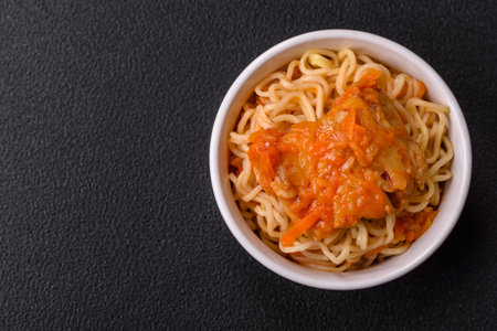 Rice noodles with fish and sauce, salt and spices on a dark concrete backgroundの写真素材