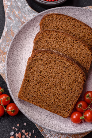 Fresh crispy brown bread sliced from whole grain flour with salt and spicesの写真素材