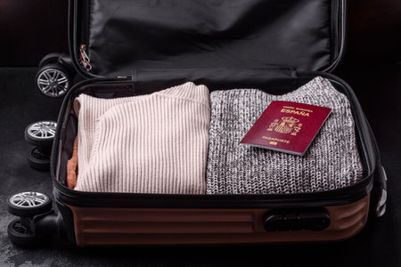 International passport of a citizen of Spain on a suitcase, departure from the airport, international travelの写真素材