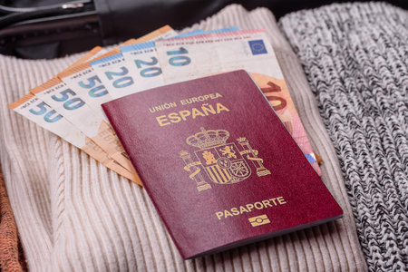 International passport of a citizen of Spain on a suitcase, departure from the airport, international travelの写真素材