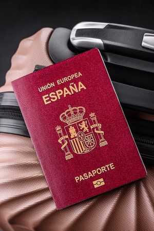 International passport of a citizen of Spain on a suitcase, departure from the airport, international travelの写真素材