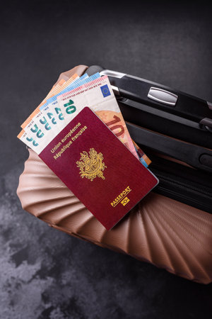 International passport of a French citizen on a suitcase, departure from the airport, international travelの写真素材