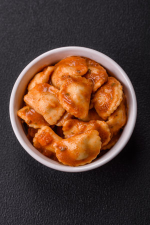 Ravioli with meat or vegetarian with ricotta, salt and spices in a ceramic plateの写真素材