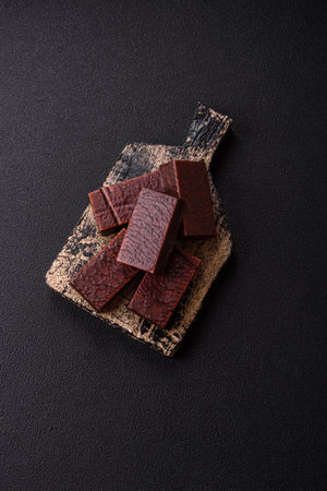 Rectangular chocolate candies on a dark concrete background