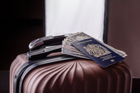 International passport of a citizen of Great Britain and Northern Ireland on a suitcase, departure from the airport, international travelの写真素材