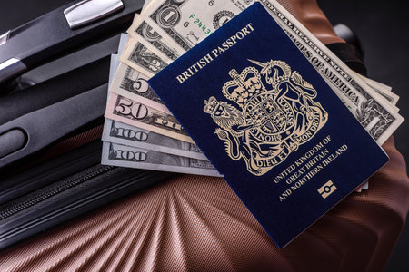 International passport of a citizen of Great Britain and Northern Ireland on a suitcase, departure...