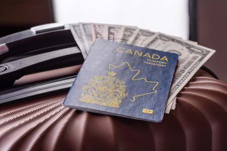 International passport of a citizen of Canada on a suitcase, departure from the airport, international travelの写真素材