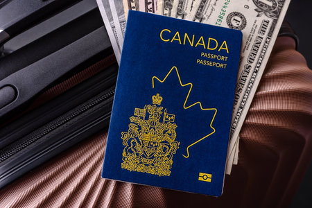 International passport of a citizen of Canada on a suitcase, departure from the airport, international travelの写真素材