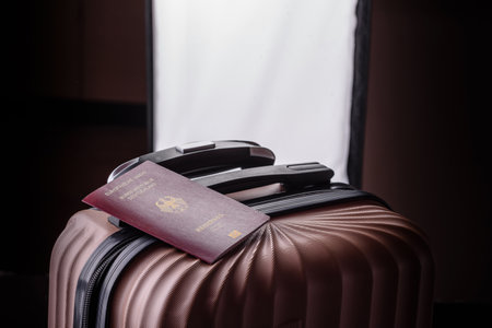 International passport of a citizen of Germany on a suitcase, departure from the airport, international travelの写真素材