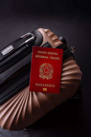 International passport of a citizen of Italy on a suitcase, departure from the airport, international travelの写真素材