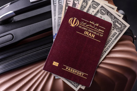 International passport of a citizen of Iran on a suitcase, departure from the airport, international travelの写真素材