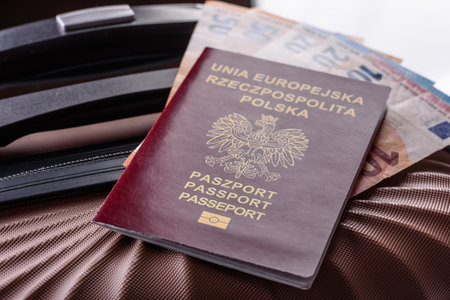 International passport of a citizen of Poland on a suitcase, departure from the airport, international travelの写真素材