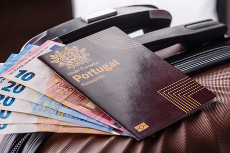 International passport of a citizen of Portugal on a suitcase, departure from the airport, international travelの写真素材