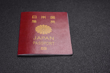 International passport of a citizen of Japan on a dark concrete background, international travel