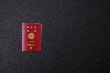 International passport of a citizen of Japan on a dark concrete background, international travelの写真素材