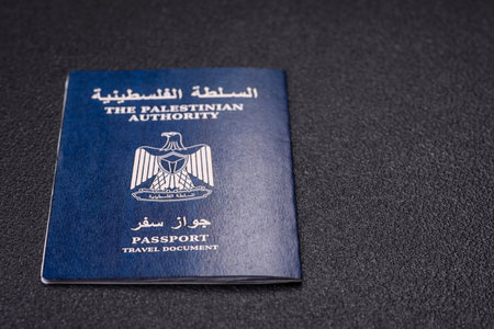 International passport of a citizen Palestine on a dark concrete background, international travel