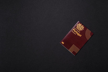 International passport of a citizen of Portugal on a dark concrete background, international travelの写真素材