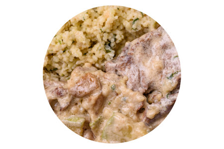 Bowl of food with bulgur, tomatoes, zucchini and sauce.の写真素材