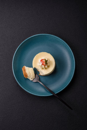 Sweet cheesecake tart with strawberries and mascarpone on a dark concrete backgroundの写真素材