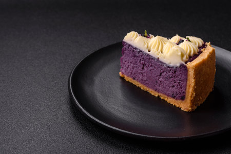 No baked sweet blueberry cheesecake with cream cheese on a dark texture backgroundの写真素材