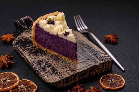 No baked sweet blueberry cheesecake with cream cheese on a dark texture backgroundの写真素材