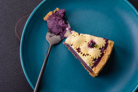 No baked sweet blueberry cheesecake with cream cheese on a dark texture background