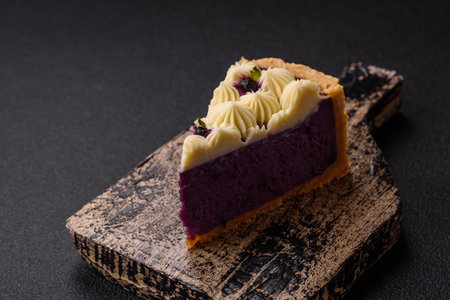 No baked sweet blueberry cheesecake with cream cheese on a dark texture backgroundの写真素材